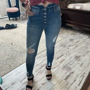 Kancan skinny frayed hem jeans with button fly.